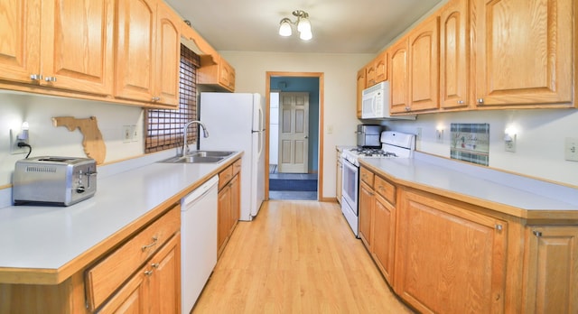61279 US Highway 169, Hill City, MN 55748 - kitchen with light countertops, a toaster, white appliances, a sink, and light wood-type flooring
