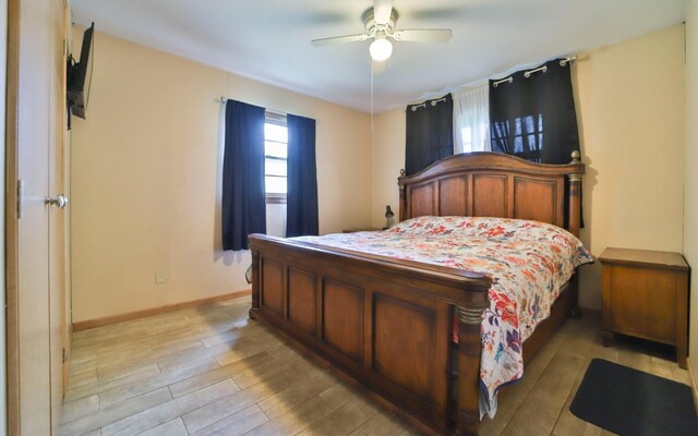 61279 US Highway 169, Hill City, MN 55748 - bedroom with baseboards, ceiling fan, and light wood-type flooring