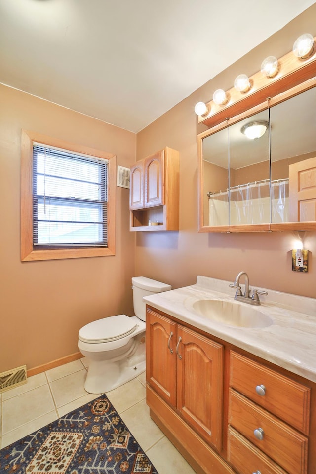 61279 US Highway 169, Hill City, MN 55748 - bathroom with toilet, vanity, tile patterned flooring, baseboards, and visible vents