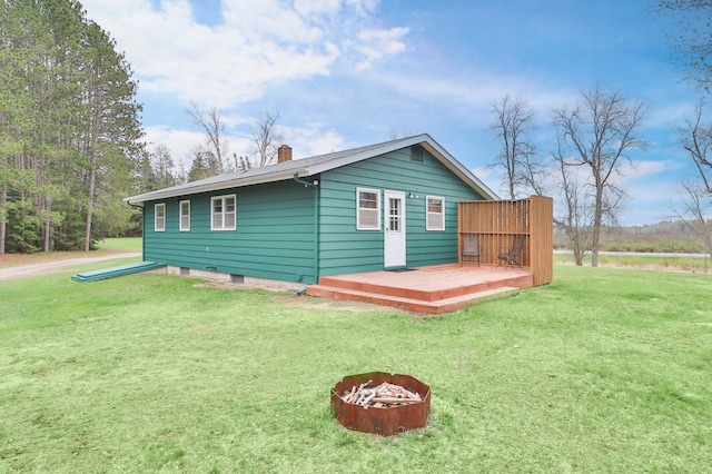 61279 US Highway 169, Hill City, MN 55748 - exterior space with an outdoor fire pit, a chimney, a yard, and a wooden deck