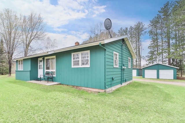 61279 US Highway 169, Hill City, MN 55748 - view of front of property with a chimney, a garage, an outdoor structure, and a front yard