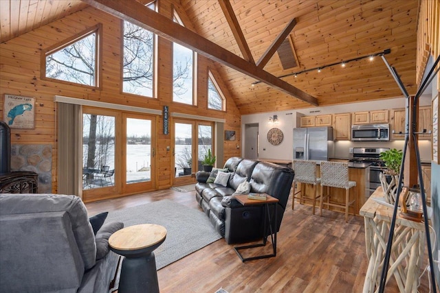 living room with wood ceiling, light wood-style flooring, and a wood stove