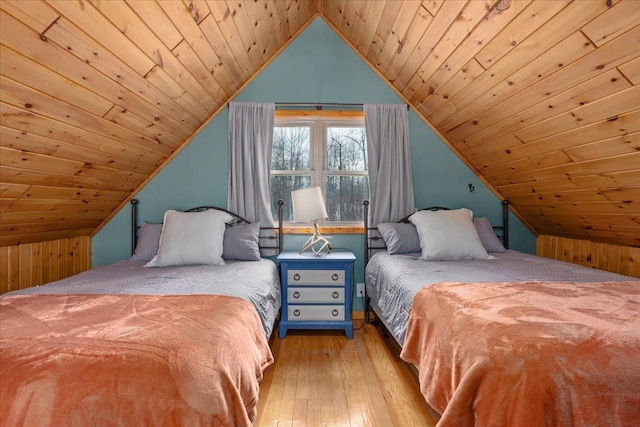 bedroom with lofted ceiling, hardwood / wood-style flooring, and wooden ceiling