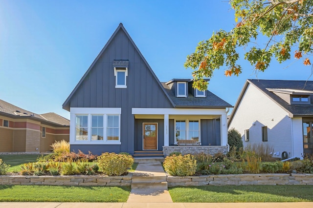 view of front of house featuring roof with shingles and board and batten siding