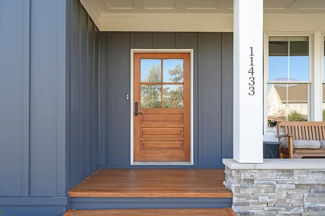 property entrance with a porch and board and batten siding