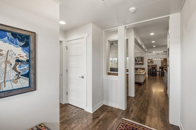 hall with recessed lighting, wood finished floors, and baseboards