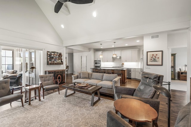 living room featuring ceiling fan, high vaulted ceiling, recessed lighting, wood finished floors, and visible vents