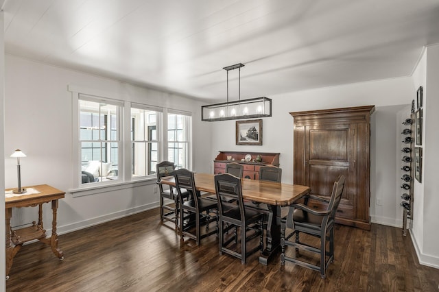 dining area with dark wood-style flooring and baseboards