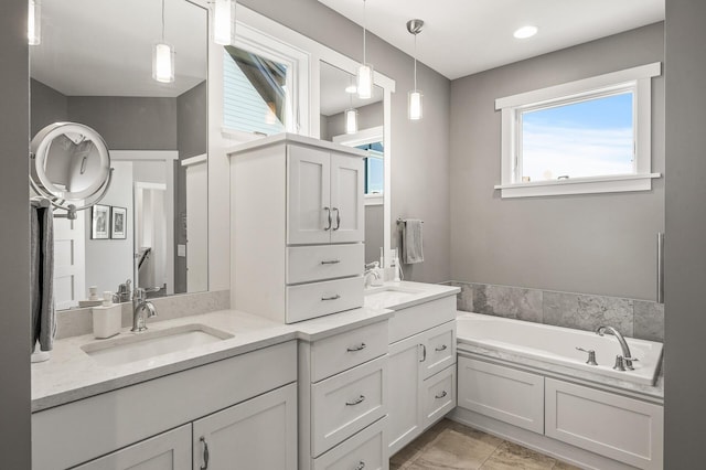 full bathroom with double vanity, a sink, and a bath