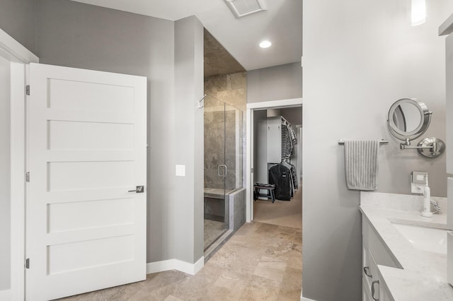 full bath with double vanity, a stall shower, visible vents, a spacious closet, and a sink