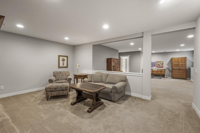 carpeted living area featuring baseboards and recessed lighting