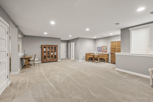 interior space featuring baseboards, light carpet, visible vents, and recessed lighting