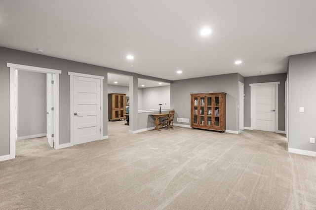 basement with baseboards, light carpet, visible vents, and recessed lighting