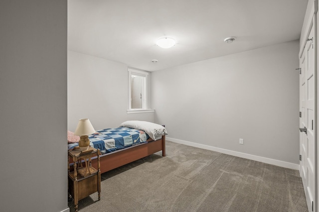 carpeted bedroom featuring baseboards