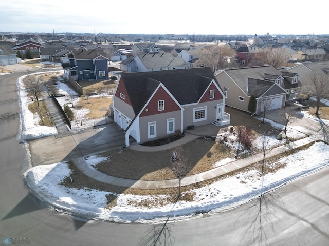 snowy aerial view featuring a residential view