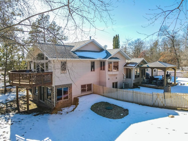 snow covered rear of property with fence private yard and cooling unit