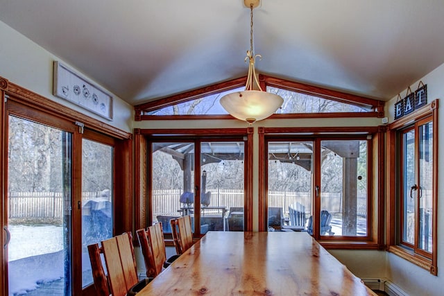 unfurnished dining area with lofted ceiling, a healthy amount of sunlight, and baseboard heating