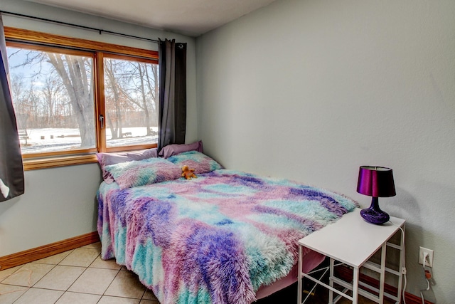 tiled bedroom featuring baseboards