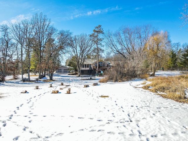 snowy yard with a detached garage