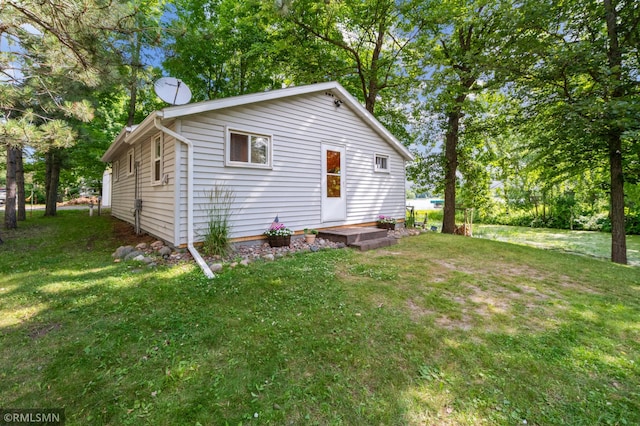 rear view of property featuring a yard