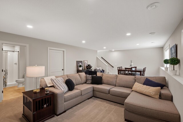 living room with stairway and recessed lighting