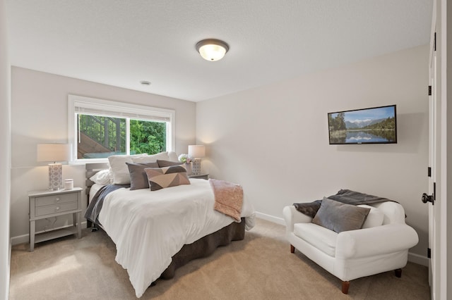 bedroom featuring light carpet and baseboards