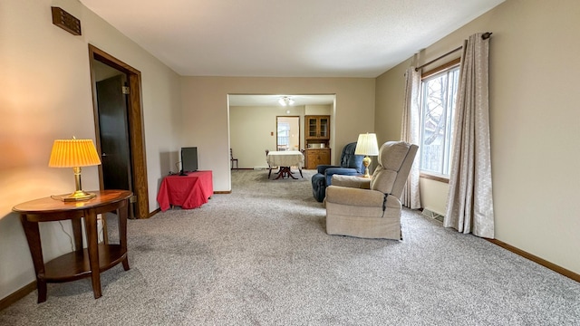 sitting room featuring carpet flooring and baseboards