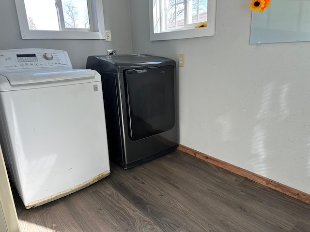 washroom with laundry area, dark wood-style flooring, a wealth of natural light, and washing machine and clothes dryer