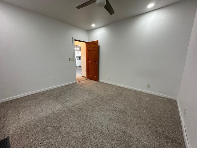 carpeted empty room with recessed lighting, a ceiling fan, and baseboards