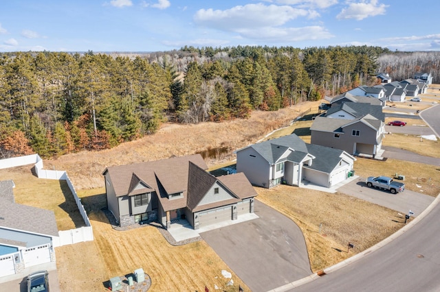 birds eye view of property with a forest view and a residential view