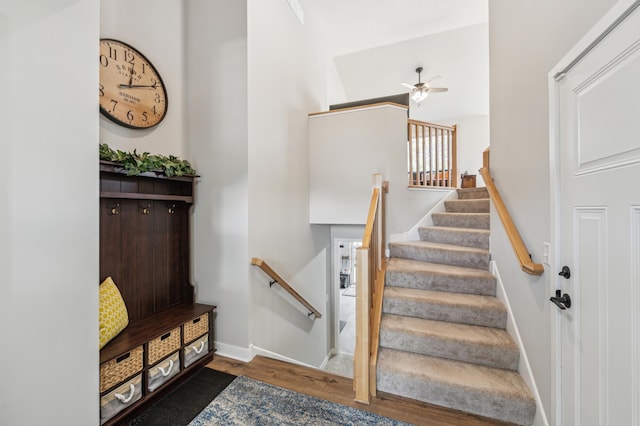 stairs with baseboards and wood finished floors