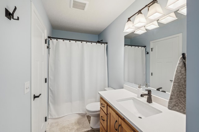 bathroom with a shower with shower curtain, visible vents, vanity, and toilet