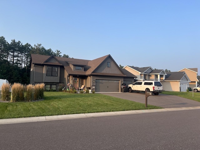 view of front of property featuring driveway, a garage, a residential view, and a front yard