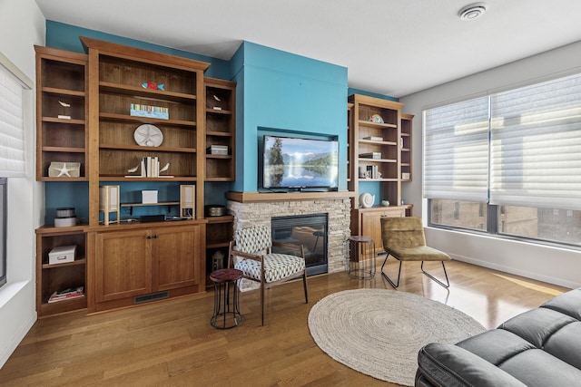 270 4th St E Unit 401, Saint Paul, MN 55101 - living room with wood finished floors, a stone fireplace, and baseboards