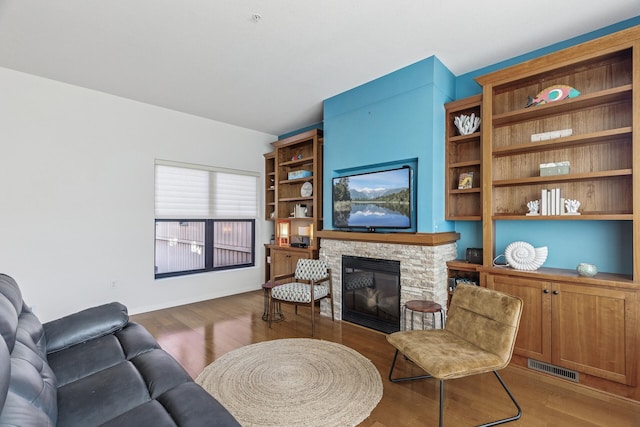 270 4th St E Unit 401, Saint Paul, MN 55101 - living room featuring wood finished floors and a stone fireplace
