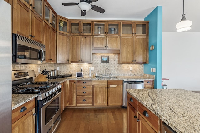 270 4th St E Unit 401, Saint Paul, MN 55101 - kitchen featuring stainless steel appliances, a sink, and brown cabinetry