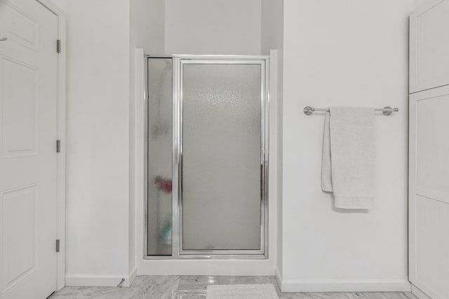 270 4th St E Unit 401, Saint Paul, MN 55101 - bathroom featuring baseboards, a shower stall, and marble finish floors