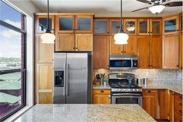 270 4th St E Unit 401, Saint Paul, MN 55101 - kitchen with stainless steel appliances, plenty of natural light, and brown cabinetry