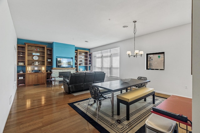 270 4th St E Unit 401, Saint Paul, MN 55101 - dining room with a chandelier, wood finished floors, and a fireplace