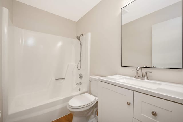 bathroom with  shower combination, wood finished floors, vanity, and toilet