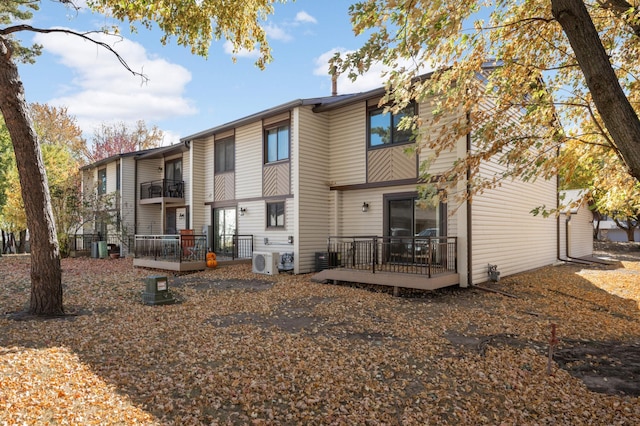 back of property with ac unit and a wooden deck