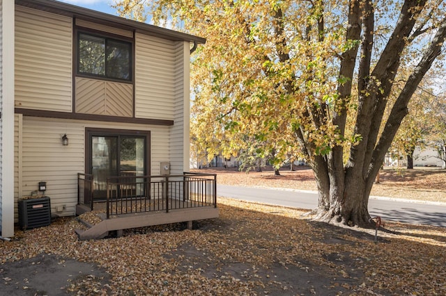 doorway to property featuring a deck and cooling unit