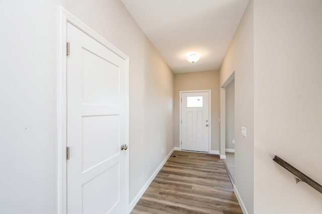 entryway with baseboards and wood finished floors