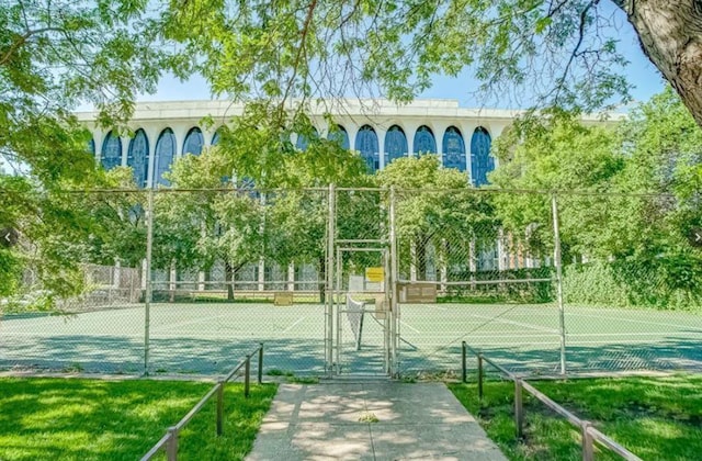 view of sport court featuring a gate and fence