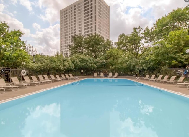 pool featuring a patio area and fence