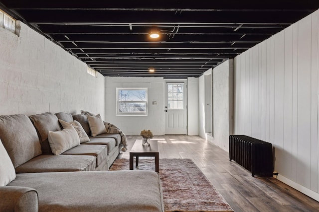 living room with radiator heating unit and wood finished floors