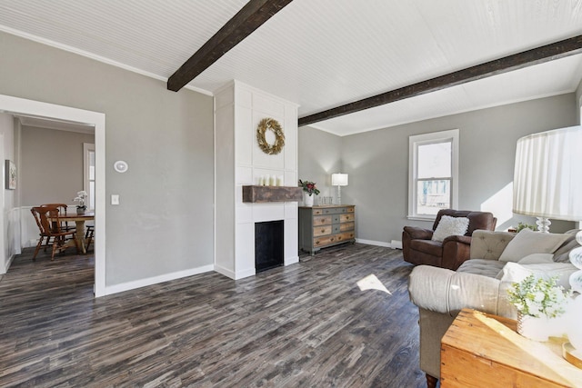 living area featuring dark wood finished floors, beamed ceiling, baseboards, and a large fireplace