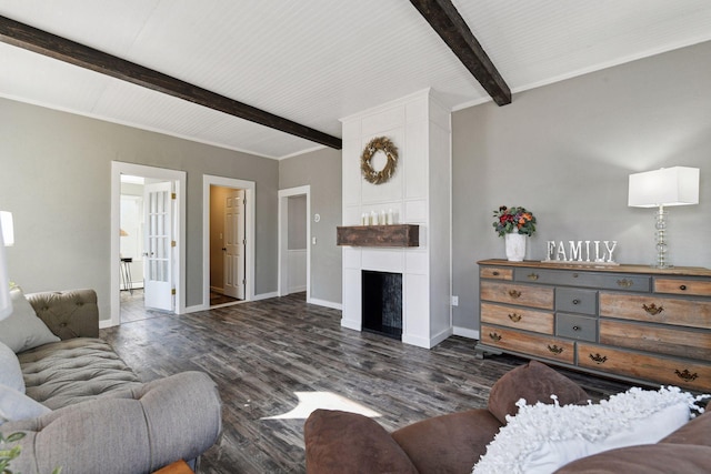 living area with dark wood-type flooring, a fireplace, baseboards, and beam ceiling