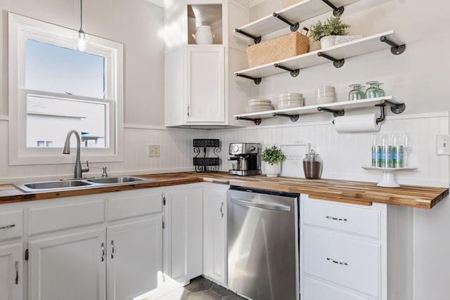 kitchen featuring a sink, wood counters, open shelves, and white cabinetry