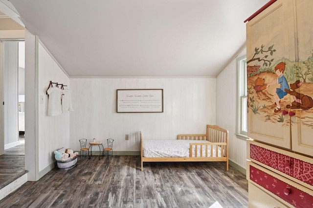 bedroom featuring baseboards, lofted ceiling, and wood finished floors